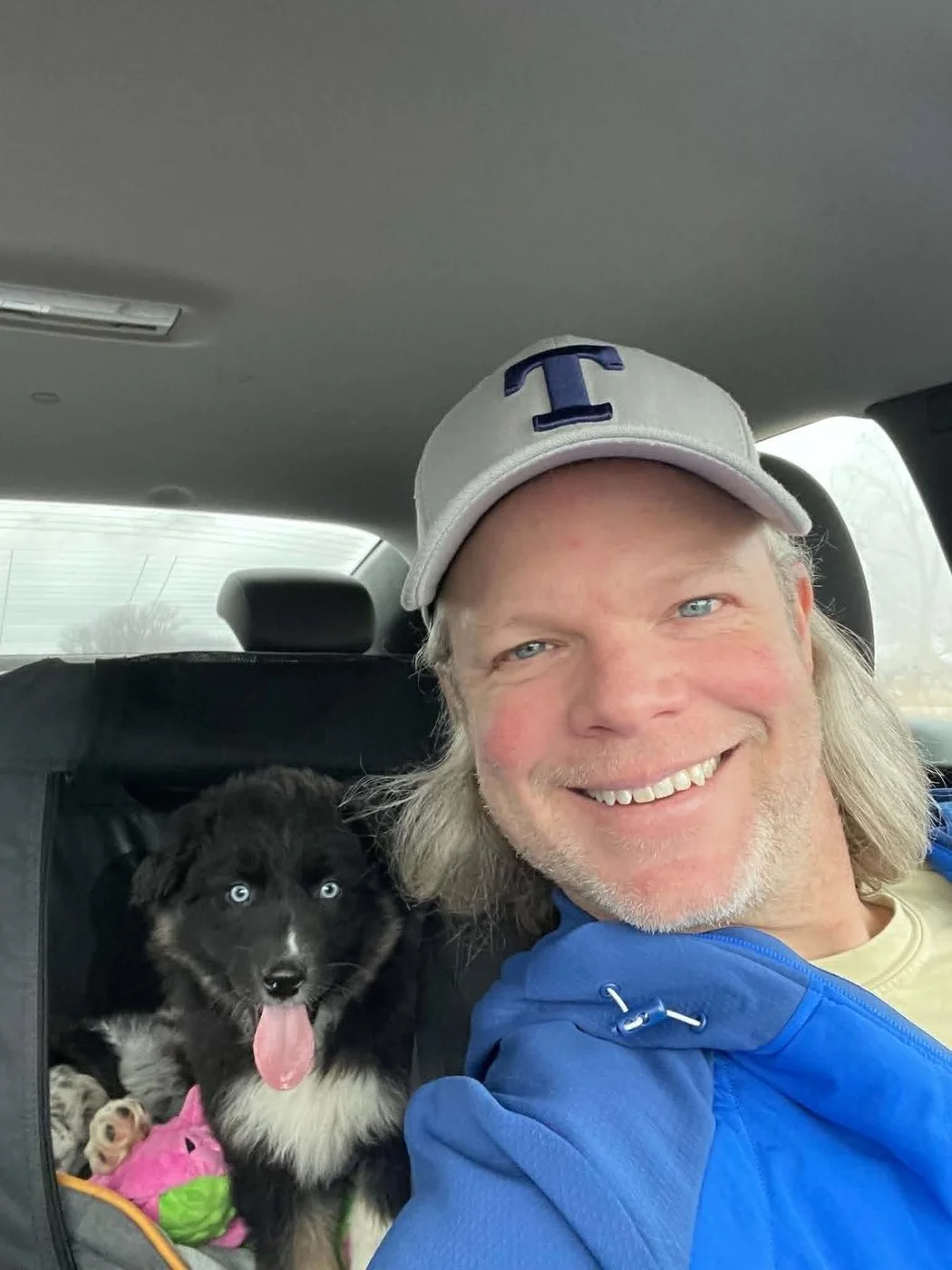 Marcia and an Australian Shepherd in a car