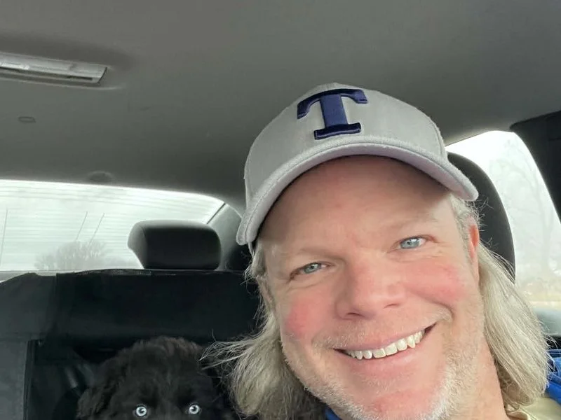 Marcia with an Australian Shepherd in a car